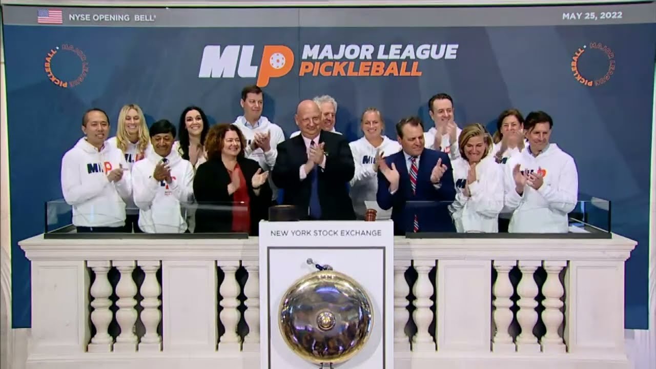 Steven Kuhn (center), founder of Major League Pickleball, rings the opening bell of the New York Stock Exchange on May 25, 2022. The game has exploded across the country to include 4.8 million players.